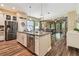 Spacious open kitchen featuring stainless appliances, island, and view into living area at 11862 Frost Aster Dr, Riverview, FL 33579