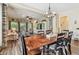 Open concept dining and living rooms with wood floors, natural light, ceiling fan, and neutral decor at 11862 Frost Aster Dr, Riverview, FL 33579