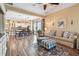 Open concept living room with wood floors, adjacent to dining area and kitchen at 11862 Frost Aster Dr, Riverview, FL 33579