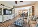 Open concept living room with wood floors seamlessly connecting to the kitchen and dining area at 11862 Frost Aster Dr, Riverview, FL 33579