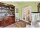 Office space with hardwood floors, a built-in bookshelf, and double doors at 11862 Frost Aster Dr, Riverview, FL 33579