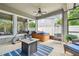 Screened-in patio featuring a hot tub, ceiling fan, and exercise equipment at 11862 Frost Aster Dr, Riverview, FL 33579
