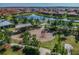 Aerial view of a community playground with various play structures, benches, sidewalks, and beautiful landscaping at 11862 Frost Aster Dr, Riverview, FL 33579
