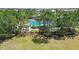 Inviting community pool area with mature trees and a nearby gathering space at 11862 Frost Aster Dr, Riverview, FL 33579