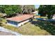 Aerial view showing a cozy house with a brick chimney and a well-kept lawn at 13116 N Oregon Ave, Tampa, FL 33612