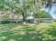 Expansive backyard featuring lush greenery, mature trees, and a charming pergola, perfect for outdoor enjoyment at 13116 N Oregon Ave, Tampa, FL 33612