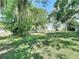 Lush backyard with mature trees, offering plenty of space and shade, perfect for relaxation and recreation at 13116 N Oregon Ave, Tampa, FL 33612