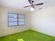 Bright bedroom featuring a ceiling fan and window with blinds at 13116 N Oregon Ave, Tampa, FL 33612
