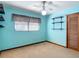 Bedroom features a ceiling fan, closet, shelving, and blue walls at 13116 N Oregon Ave, Tampa, FL 33612