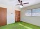 Bedroom featuring a ceiling fan, closet, and a window at 13116 N Oregon Ave, Tampa, FL 33612