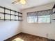 Cozy bedroom featuring a ceiling fan, window with curtains, and shelving at 13116 N Oregon Ave, Tampa, FL 33612