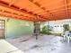 Wide angle view of covered carport, the detached garage and adjacent yard at 13116 N Oregon Ave, Tampa, FL 33612
