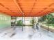 Large covered patio adjacent to a detached garage at 13116 N Oregon Ave, Tampa, FL 33612
