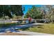 Well-maintained house with a brick chimney, cozy carport, and neatly manicured lawn at 13116 N Oregon Ave, Tampa, FL 33612