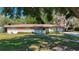 Quaint single-story house with red brick accents, well-maintained lawn, and a cozy, inviting entrance at 13116 N Oregon Ave, Tampa, FL 33612
