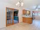 View of kitchen with tile flooring, wood cabinets, breakfast bar, and sliding glass door at 13116 N Oregon Ave, Tampa, FL 33612