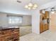 Open concept kitchen with brick accent wall and breakfast bar open to living room at 13116 N Oregon Ave, Tampa, FL 33612