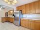 Spacious kitchen with stainless steel refrigerator, lots of oak cabinets, and tile flooring at 13116 N Oregon Ave, Tampa, FL 33612