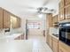 Kitchen with stainless steel refrigerator, cooktop, oven, light countertop, and tile floor at 13116 N Oregon Ave, Tampa, FL 33612
