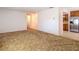 Spacious living room with carpet, view to kitchen area, neutral walls and ceiling at 13116 N Oregon Ave, Tampa, FL 33612