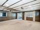 Bright and airy living room with wood paneling, carpet, large windows, and access to a porch at 13116 N Oregon Ave, Tampa, FL 33612