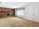Living room with carpeted floor, brick fireplace, and front door at 13116 N Oregon Ave, Tampa, FL 33612