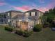 Aerial view of home with outdoor kitchen, screened in patio, and lush backyard at 13143 Palmilla Cir, Dade City, FL 33525