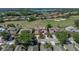 Expansive aerial shot showcasing the home's location on a golf course with mature trees at 13143 Palmilla Cir, Dade City, FL 33525