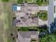 Aerial view of a meticulously maintained home with an enclosed pool and lush landscaping at 13143 Palmilla Cir, Dade City, FL 33525