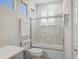 Bright bathroom showcases a glass-enclosed tub/shower and crisp, clean design at 13143 Palmilla Cir, Dade City, FL 33525