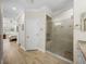 Bathroom featuring a glass-enclosed shower with built-in bench and tile surround at 13143 Palmilla Cir, Dade City, FL 33525
