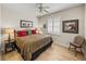 Bedroom featuring a bed with patterned bedding, wood-look flooring, ceiling fan, and shuttered window at 13143 Palmilla Cir, Dade City, FL 33525
