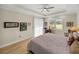 Spacious bedroom with bright natural light, desk, golf clubs, and serene views at 13143 Palmilla Cir, Dade City, FL 33525
