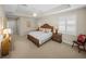 Bright bedroom boasts neutral walls, tray ceiling, and carpeted floors, offering a comfortable retreat at 13143 Palmilla Cir, Dade City, FL 33525
