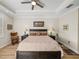 Inviting bedroom featuring a ceiling fan, tray ceiling, and side tables with lamps at 13143 Palmilla Cir, Dade City, FL 33525