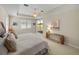 Relaxing bedroom with golf course view, light walls, and a sliding glass door to a private balcony at 13143 Palmilla Cir, Dade City, FL 33525