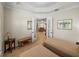 Bedroom featuring neutral colored twin beds with adjoining sitting room, wood-look floors and tray ceilings at 13143 Palmilla Cir, Dade City, FL 33525