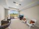 Relaxing bonus room with sliding glass doors, outdoor views, and comfortable seating arrangement at 13143 Palmilla Cir, Dade City, FL 33525