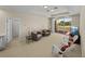 Inviting bonus room with comfortable seating and views of the lush outdoor landscape at 13143 Palmilla Cir, Dade City, FL 33525