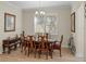 Traditional dining room with wood table, chairs, chandelier, and large window at 13143 Palmilla Cir, Dade City, FL 33525