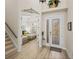 Foyer showcasing a decorative front door and staircase leading to an upstairs bedroom with twin beds at 13143 Palmilla Cir, Dade City, FL 33525