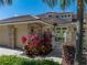 Close-up of the front exterior showcasing the home's brick accents and meticulous landscaping at 13143 Palmilla Cir, Dade City, FL 33525