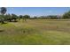 Open green space of the golf course with mature trees and landscaping at 13143 Palmilla Cir, Dade City, FL 33525