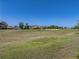 Lush green golf course view with sand traps under a clear blue sky at 13143 Palmilla Cir, Dade City, FL 33525