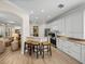 Bright, modern kitchen with white cabinets, stainless steel appliances, and a breakfast bar with seating at 13143 Palmilla Cir, Dade City, FL 33525
