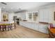Bright kitchen with white cabinets, wood flooring, a breakfast bar, and stainless steel appliances at 13143 Palmilla Cir, Dade City, FL 33525