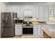 Close-up of the kitchen with stainless steel appliances, ample cabinetry, and modern design at 13143 Palmilla Cir, Dade City, FL 33525