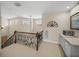 Upper landing area with wet bar, cozy seating, and an abundance of natural light at 13143 Palmilla Cir, Dade City, FL 33525