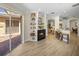 Open living room with fireplace, built-in shelves, and sliding doors to a brick patio at 13143 Palmilla Cir, Dade City, FL 33525