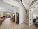 Bright and airy living room featuring an ornate staircase and seamless transition to the outdoor patio at 13143 Palmilla Cir, Dade City, FL 33525